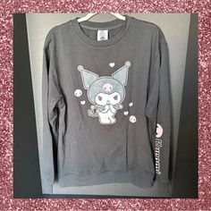 It’s Sweater Weather And This Is The Softest Long Sleeve Sweatshirt And One Of The Cutest. Kuromi Is Printed On The Front Of This Black Sweatshirt And Her Name Is On One Sleeve. If You Love The Sweet Yet Mischievous Kuromi This Brand New Sweatshirt Is Perfect For You. Size M Length 27” Width 22” 60% Cotton And 40% Polyester Machine Washable And Tumble Dry Low Official Licensed Sanrio Item Cute Long Sleeve Tops For Streetwear, Kawaii Long Sleeve Tops For Fall, Kawaii Long Sleeve T-shirt For Streetwear, Pink Kawaii Long Sleeve Sweatshirt, Pink Long Sleeve Kawaii Sweatshirt, Kawaii Cotton Tops For Loungewear, Cute Long Sleeve Sweater With Graphic Print, Cute Long Sleeve Graphic Sweater, Cotton Kawaii Tops For Loungewear