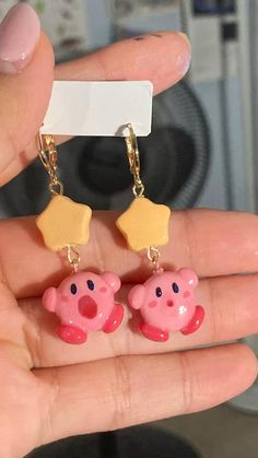 a pair of pig earrings is shown in front of a camera