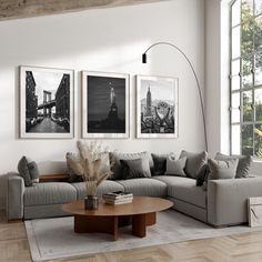 a living room with three pictures on the wall and a coffee table in front of it