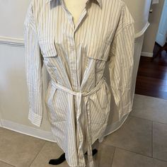 New With Tags Woman’s Gap Button Down Shirt Dress With Tie Around The Waist Size Small. It’s Black And Cream Colored Striped Dress With Two Buttoned Pockets On Top And Two Pockets On Waist. The Belt Is Detachable. The Original Price Tag Is Still On The Dress For.$79.95. From The Middle Of The Shoulder To The Bottom Of The Front Of The Dress Is 34” And It’s 100% Cotton. Neutral Long Sleeve Shirt Dress Casual, Neutral Long Sleeve Shirt Dress For Daywear, Beige Cotton Shirt Dress For Daywear, Beige Button-up Cotton Dress, Beige Long Sleeve Cotton Shirt Dress, Chic Cream Shirt Dress For Work, Chic Long Sleeve Neutral Shirt Dress, Casual Cream Shirt Dress For Daywear, Fitted Gap Dress With Buttons