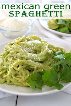 mexican green spaghetti on a plate with cilantro and parsley