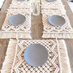 the table is set with plates and placemats on top of woven doily