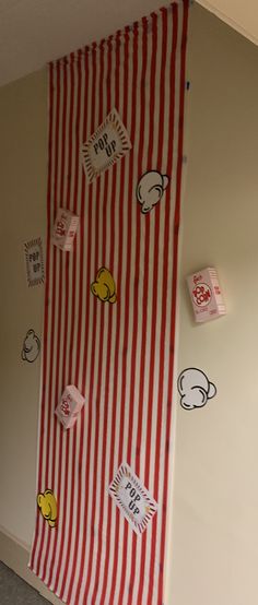 there is a red and white striped wall with stickers all over it that says hello kitty