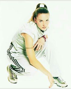 a woman kneeling down with her hand on her hip