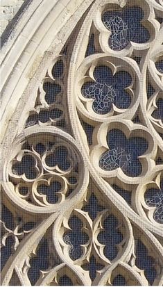 an intricately designed window on the side of a building