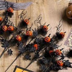 halloween decorations are arranged on a wooden table