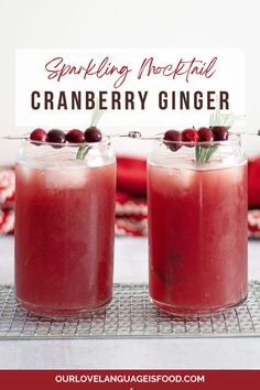 two glasses filled with cranberry ginger drink on top of a wire cooling rack