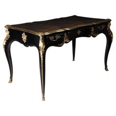 an antique black and gold desk with drawers