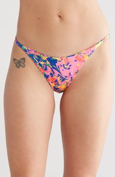 Make a splash in this vibrant reversible print bikini bottoms while you soak up the sun by the poolside. Pattern on reverse side may vary 52% regenerate polyamide, 30% polyamide, 18% spandex Hand wash, dry flat Imported Vibrant Stretch Swimwear For Sunbathing, Vibrant Stretch Swimwear For Pool, Colorful Stretch Swimwear For Pool, Vibrant Summer Swim Bottoms, Multicolor Bottoms For Pool And Beach Season, Multicolor Beach Season Bottoms For Pool, Vibrant Summer Swimming Bottoms, Multicolor Tie-side Swimming Bottoms, Vibrant Printed Swimwear For Poolside