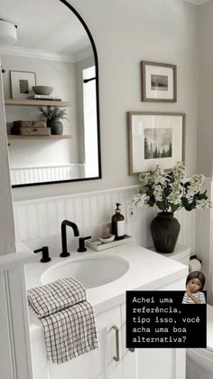 a bathroom with a sink, mirror and pictures on the wall above it that says do you know what this is?