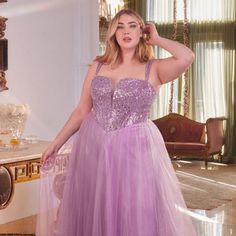 Indulge In The Enchanting Allure Of Our New Formal Sleeveless Plus Size A-Line Tulle Gown, Perfect For Your Next Formal Event. This Exquisite Gown Is Crafted With Delicate Embroidery And Sparkling Sequins, Draping You In An Ethereal Layer Of Tulle That Creates A Dreamy Fairytale-Like Vibe. Designed With Your Curves In Mind, This Gown Is Perfect For Plus-Size Women Who Want To Look And Feel Their Best On Their Special Occasion. Fabric: Tulle Length: Long Color: Dusty Lavender Neckline: Plunging V Purple Sleeveless Tulle Evening Dress, Sleeveless Sequined Ball Gown For Wedding, Sleeveless Sequin Ball Gown For Prom, Sleeveless Sequin Wedding Ball Gown, Sleeveless Ball Gown For Debutante Ball, Sleeveless Gown With Corset Back For Debutante Ball, Sleeveless Tulle Ball Gown With Fitted Bodice, Purple Sleeveless Tulle Gown, Sleeveless Corset Back Dress For Debutante Ball