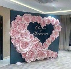 there is a large heart made out of pink roses on the wall in this room