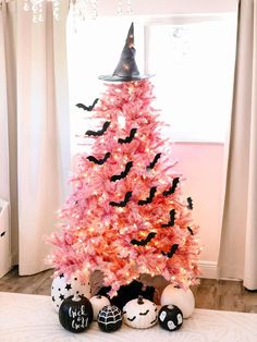 a pink christmas tree with bats on it