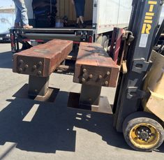 a forklift with two pieces of wood on it