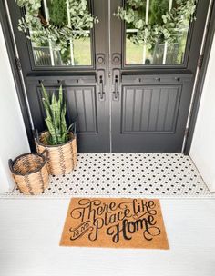 a door mat that says, there is no place like home on the front porch