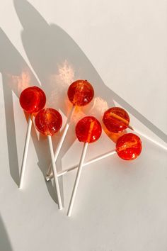 four lollipops sitting on top of each other in front of a white background