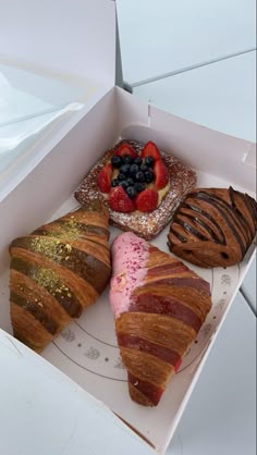 four different types of pastries in a box