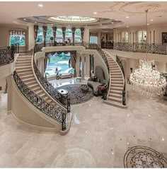 a large living room with stairs and chandelier