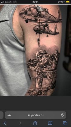 a man's arm with an army tattoo on it and a helicopter flying over him