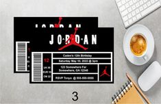 a pair of black and red air jordan ticket cards next to a cup of coffee