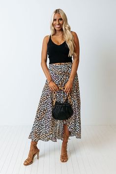 There is no better piece to make an outfit with than our pretty peach colored 'Only Sunshine' skirt featuring lightweight breezy material patterned with a black leopard print print, a high waistline, and a relaxed silhouette that falls into a high/low tulip hemline!                                         Measurements XS variant has  a Hip of 32",  a Length of 36",  a Slip Length of 16.5",  a Waist of 24".  S variant has  a Hip of 34",  a Length of 36.5",  a Slip Length of 17",  a Waist of 26". Casual Leopard Print Skirt For Summer, Chic Leopard Print Vacation Bottoms, Chic Leopard Print Skirt For Day Out, Leopard Print Skirt For Summer Day Out, Casual Leopard Print Flowy Skirt, Casual Flowy Leopard Print Skirt, Leopard Print Long Skirt For Spring, Chic Leopard Print Skirt For Spring, Long Leopard Print Skirt For Spring