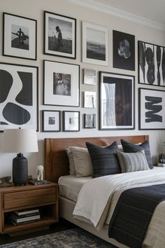 a bedroom with pictures on the wall above the bed