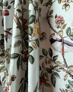 the curtains are decorated with birds and flowers