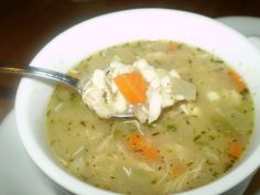 a white bowl filled with chicken and dumpling soup