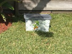 a plastic container sitting in the grass