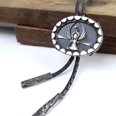 The Guardian Moon Keeper. When there's repairs to be done, this little Guardian Moon Keeper selects which two halves to send up each night. Handmade sterling silver bolo tie with a beautiful flashy blue labradorite gemstone.  Pendant measures 4.2cm by 3.3cm.  Sterling silver cord ends. Comes on dark blue round leather cord. Cord length measures 34 inches Cord thickness is 3mm Includes gift box. Handmade by Silversmith and Lapidary Artist Annie Summers. Annie has recently moved from the UK to the USA and this bolo tie will come in one of her Jewellery FurKeeps gift boxes. Handmade with Love, Forever FurKeeps! We are husband and wife Mike and Annie, making silver jewelry in two uniquely different styles. With a passion for rocks and gemstones, we also cut and polish our own cabochons to use Artisan Silver Jewelry With Adjustable Length, Elegant Silver Bolo Tie As Gift, Elegant Silver Bolo Ties As A Gift, Handmade Elegant Bolo Ties As A Gift, Handmade Elegant Bolo Ties For Gift, Silver Engraved Lariat Jewelry, Engraved Silver Lariat Jewelry, Handmade Silver Bolo Tie As A Gift, Handmade Silver Bolo Tie For Gift