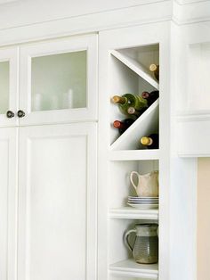 an open cabinet with wine bottles in it