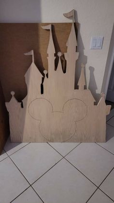 a wooden cutout of a castle on the floor