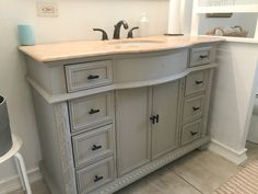 a bathroom vanity with two sinks and drawers