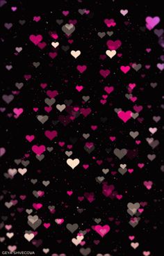 pink and black hearts are flying in the air on a dark background with space for text