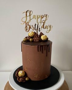 a birthday cake with chocolate and gold decorations