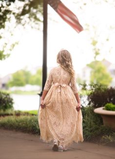 One of our most popular dresses has arrived in a stunning long gown. This vintage inspired lace frock is absolutely gorgeous in person. The color is a dreamy gold and photographs amazing. The lace is soft, not scratchy and has a French eyelash edging, creating a perfect touch of vintage whimsy. The dress is fully lined with soft cotton and has a back zipper. The sparkle belt is completely removable and self ties in back for just the right touch of sweetness. 100% poly self, 100% soft cotton lini Gown Belt, Trish Scully, Lace Frocks, Popular Dresses, Long Gown, Girl Dresses, Belted Dress, Childrens Clothes, Vintage Inspired