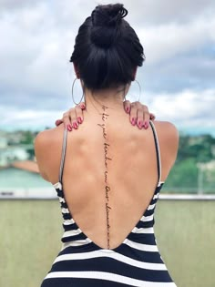 the back of a woman's neck with writing on it