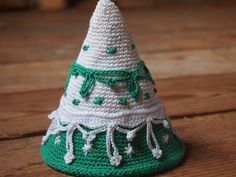 a crocheted green and white christmas tree decoration