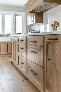 a kitchen with wooden cabinets and white walls