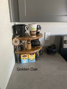 there is a shelf with coffee cups on it in the corner of this kitchen area