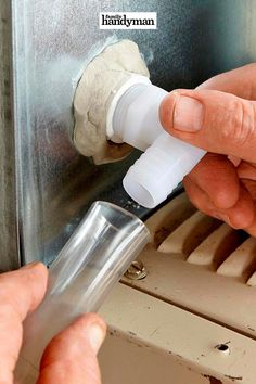 a person is using an air freshener dispenser to clean the air