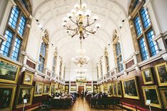 a large room filled with paintings and chandeliers