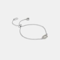 Accented with our Signature in glittering pavé crystals this delicate chain bracelet is detailed with a sparkling crystal stud. This minimalist design features a sliding bead bolo closure that adjusts to most wrists. | Coach Signature Pavé Slider Bracelet - Women's - Silver & Clear Slider Bracelet, Delicate Chain, Jewelry Inspo, Sparkling Crystal, Women Accessories Jewelry, Silver Bracelets, Womens Jewelry Bracelets, Womens Bracelets, Chain Bracelet