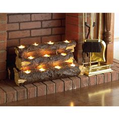 a fire place with candles on it in front of a brick fireplace