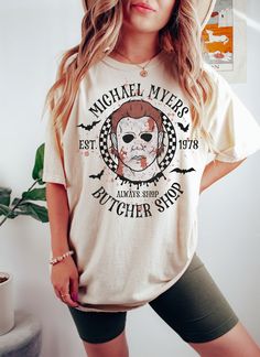 a woman wearing a michael myers t - shirt and shorts