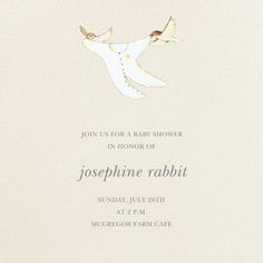 a white card with gold foil on it and a bird flying in the sky above