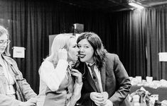 black and white photograph of three women talking to each other