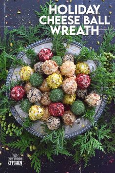 holiday cheese ball wreath on a platter with berries and pine cones in the center