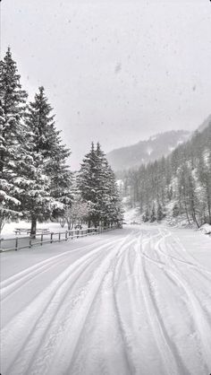 black and white photograph of snow covered road