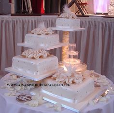 three tiered white wedding cake on a table